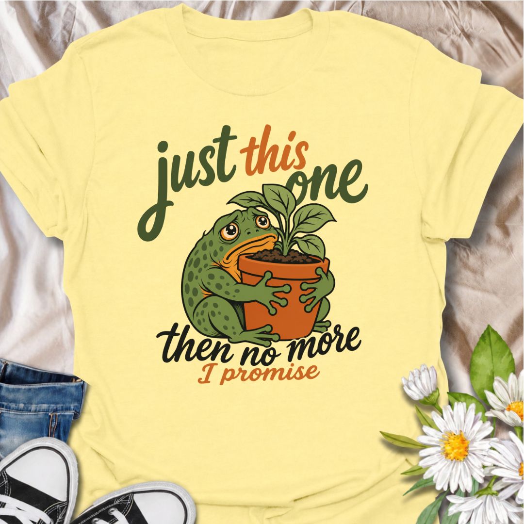 A funny plant T-shirt for anyone who swears every new purchase really will be the last one. The phrase “Just This One, Then No More. I Promise.” pairs with a wide-eyed frog hugging a potted plant for playful, instantly relatable plant-parent humor. It is perfect for houseplant lovers, plant collectors, nursery regulars, and anyone who can never quite resist one more plant. The character-led artwork gives the design plenty of personality while keeping the joke clear and easy to wear. A great gift for plant l