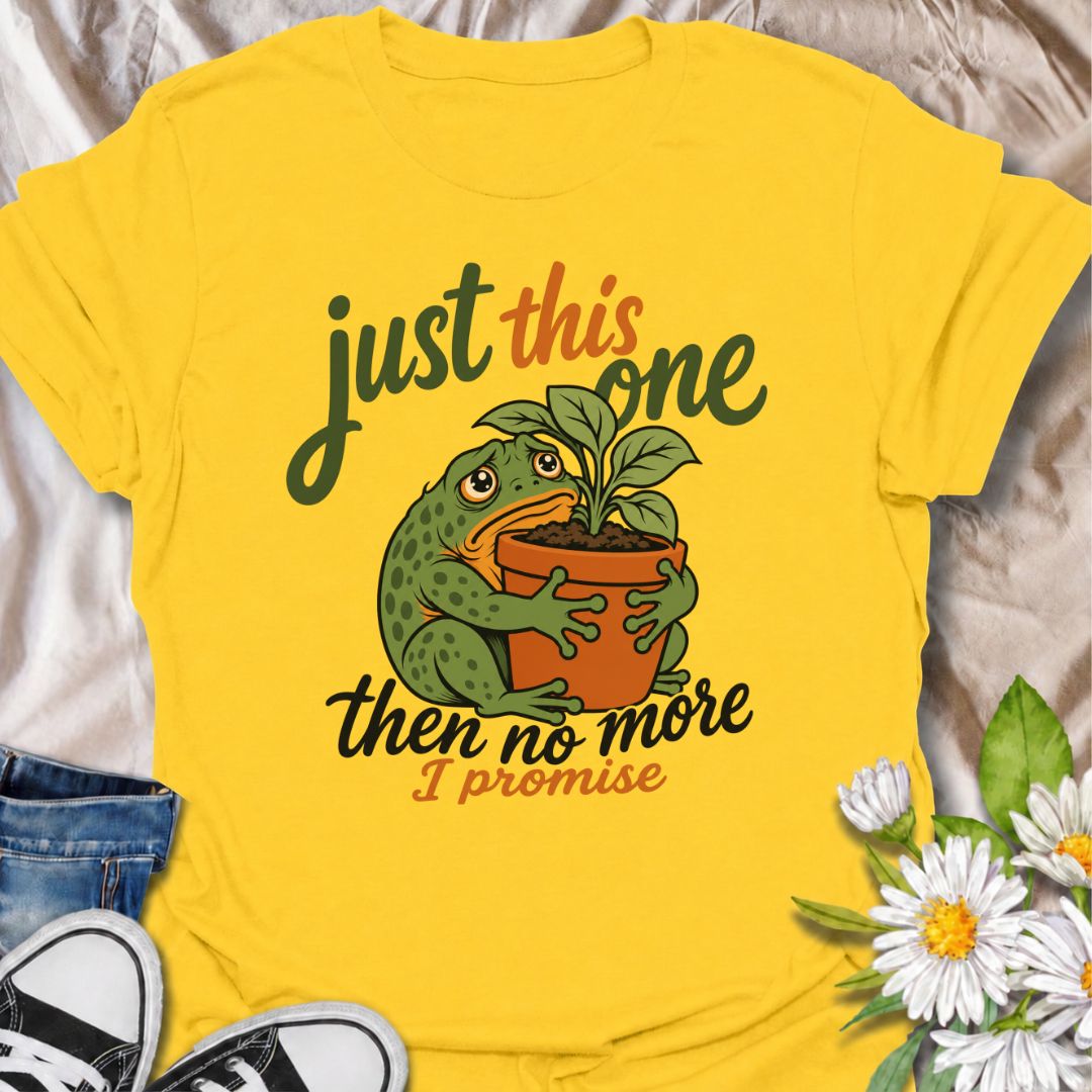 A funny plant T-shirt for anyone who swears every new purchase really will be the last one. The phrase “Just This One, Then No More. I Promise.” pairs with a wide-eyed frog hugging a potted plant for playful, instantly relatable plant-parent humor. It is perfect for houseplant lovers, plant collectors, nursery regulars, and anyone who can never quite resist one more plant. The character-led artwork gives the design plenty of personality while keeping the joke clear and easy to wear. A great gift for plant l
