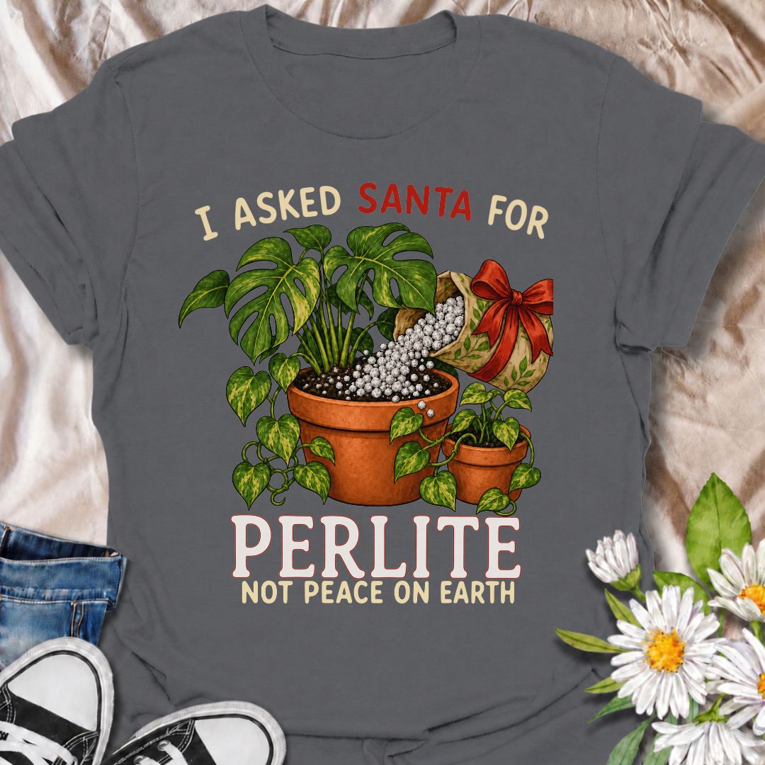 A funny Christmas plant T-shirt for houseplant lovers who would rather find gardening supplies under the tree than another ordinary gift. The phrase “I Asked Santa for Perlite, Not Peace on Earth” pairs with lush potted plants and a festive bag of perlite for niche holiday plant humor. It is perfect for plant parents, indoor gardeners, propagation fans, and anyone who takes their potting mix very seriously. The Christmas colors and botanical artwork make it festive without losing the plant-lover personality