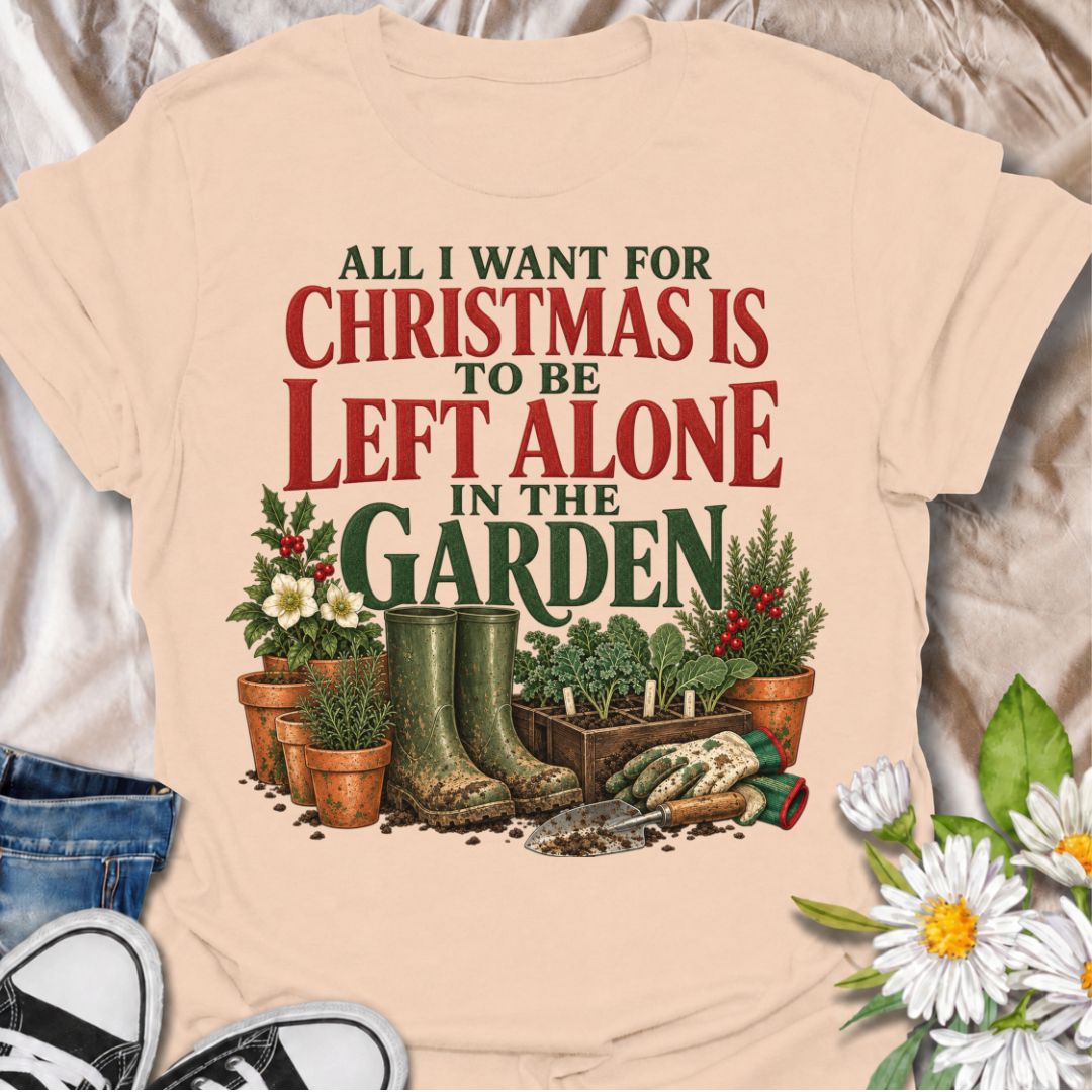 A funny Christmas gardening T-shirt for anyone whose perfect holiday involves escaping outside and being left alone with the plants. The phrase “All I Want for Christmas Is to Be Left Alone in the Garden” pairs with muddy wellies, gloves, a hand trowel, herbs, and festive holly for a design made especially for real gardeners. It is perfect for backyard gardeners, flower growers, vegetable gardeners, and anyone who would rather spend Christmas pottering outside than making small talk indoors. The vintage-sty