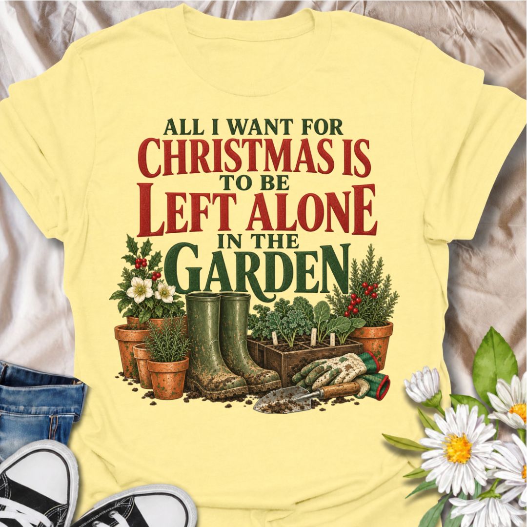 A funny Christmas gardening T-shirt for anyone whose perfect holiday involves escaping outside and being left alone with the plants. The phrase “All I Want for Christmas Is to Be Left Alone in the Garden” pairs with muddy wellies, gloves, a hand trowel, herbs, and festive holly for a design made especially for real gardeners. It is perfect for backyard gardeners, flower growers, vegetable gardeners, and anyone who would rather spend Christmas pottering outside than making small talk indoors. The vintage-sty