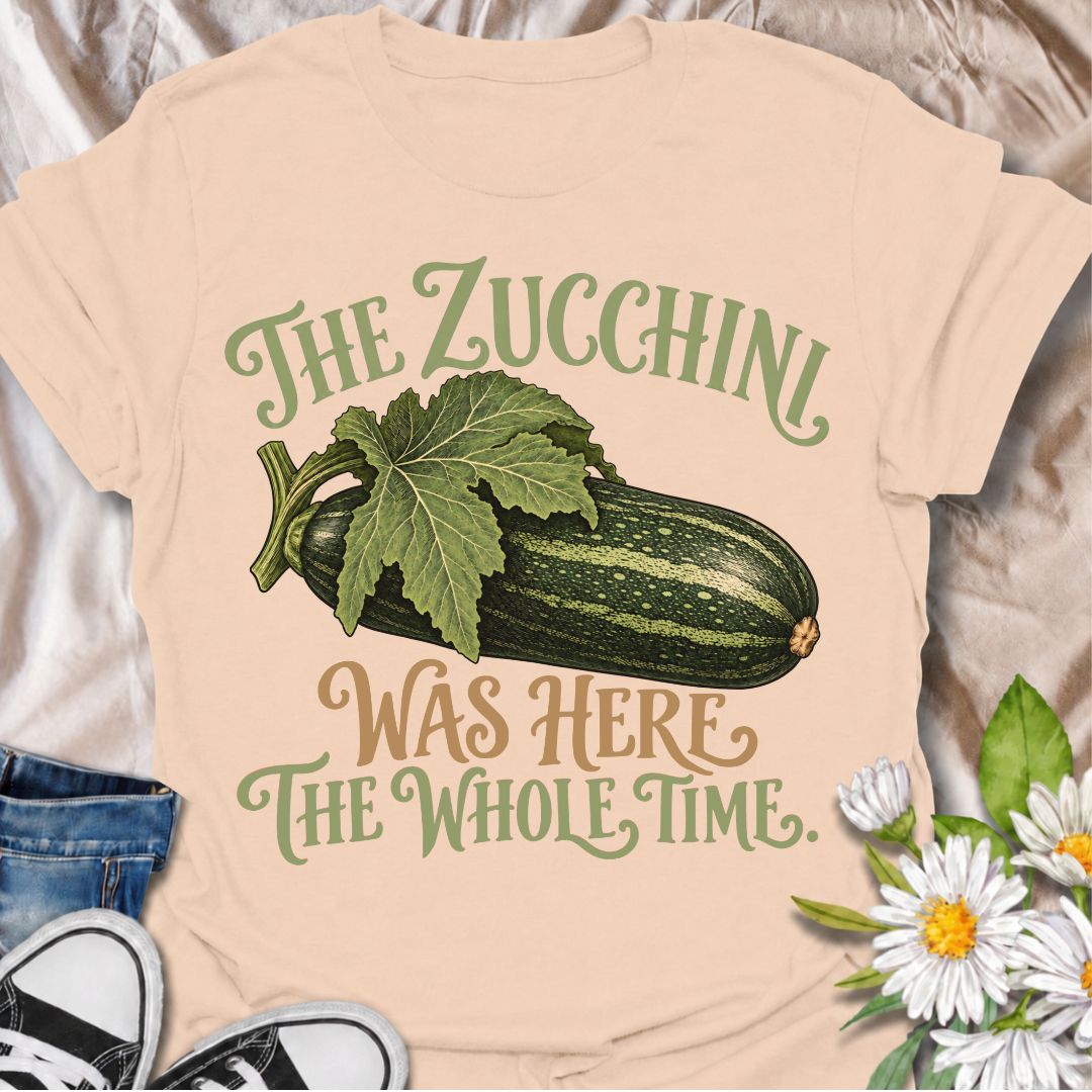 A funny gardening T-shirt for anyone who has ever overlooked a zucchini until it suddenly became enormous. The phrase “The Zucchini Was Here the Whole Time” captures that very specific vegetable-gardener moment with dry, relatable humor. Featuring a large vintage-style zucchini and leafy stem, the design is perfect for backyard gardeners, raised-bed growers, and anyone familiar with surprise harvests. It makes a great gift for vegetable gardeners, zucchini growers, and people who know how quickly squash can