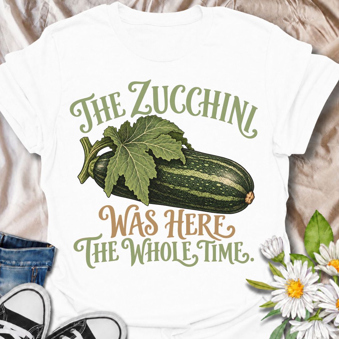 A funny gardening T-shirt for anyone who has ever overlooked a zucchini until it suddenly became enormous. The phrase “The Zucchini Was Here the Whole Time” captures that very specific vegetable-gardener moment with dry, relatable humor. Featuring a large vintage-style zucchini and leafy stem, the design is perfect for backyard gardeners, raised-bed growers, and anyone familiar with surprise harvests. It makes a great gift for vegetable gardeners, zucchini growers, and people who know how quickly squash can