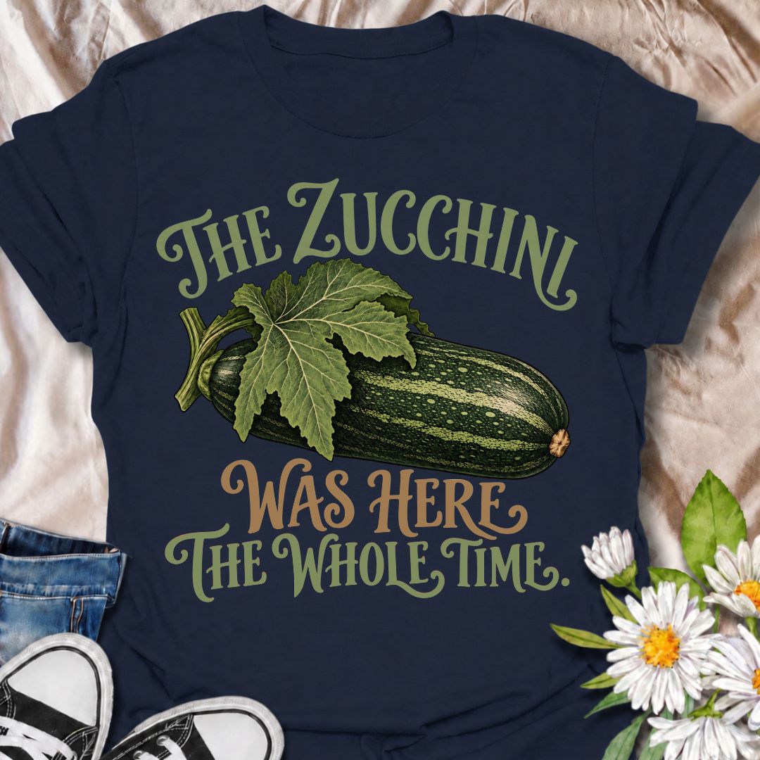 A funny gardening T-shirt for anyone who has ever overlooked a zucchini until it suddenly became enormous. The phrase “The Zucchini Was Here the Whole Time” captures that very specific vegetable-gardener moment with dry, relatable humor. Featuring a large vintage-style zucchini and leafy stem, the design is perfect for backyard gardeners, raised-bed growers, and anyone familiar with surprise harvests. It makes a great gift for vegetable gardeners, zucchini growers, and people who know how quickly squash can