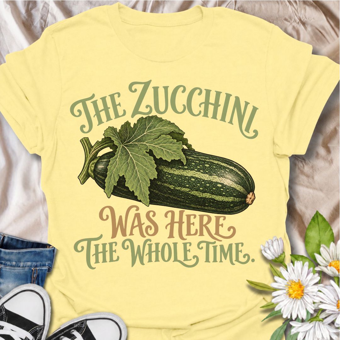 A funny gardening T-shirt for anyone who has ever overlooked a zucchini until it suddenly became enormous. The phrase “The Zucchini Was Here the Whole Time” captures that very specific vegetable-gardener moment with dry, relatable humor. Featuring a large vintage-style zucchini and leafy stem, the design is perfect for backyard gardeners, raised-bed growers, and anyone familiar with surprise harvests. It makes a great gift for vegetable gardeners, zucchini growers, and people who know how quickly squash can