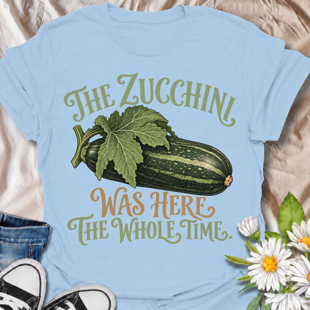 A funny gardening T-shirt for anyone who has ever overlooked a zucchini until it suddenly became enormous. The phrase “The Zucchini Was Here the Whole Time” captures that very specific vegetable-gardener moment with dry, relatable humor. Featuring a large vintage-style zucchini and leafy stem, the design is perfect for backyard gardeners, raised-bed growers, and anyone familiar with surprise harvests. It makes a great gift for vegetable gardeners, zucchini growers, and people who know how quickly squash can