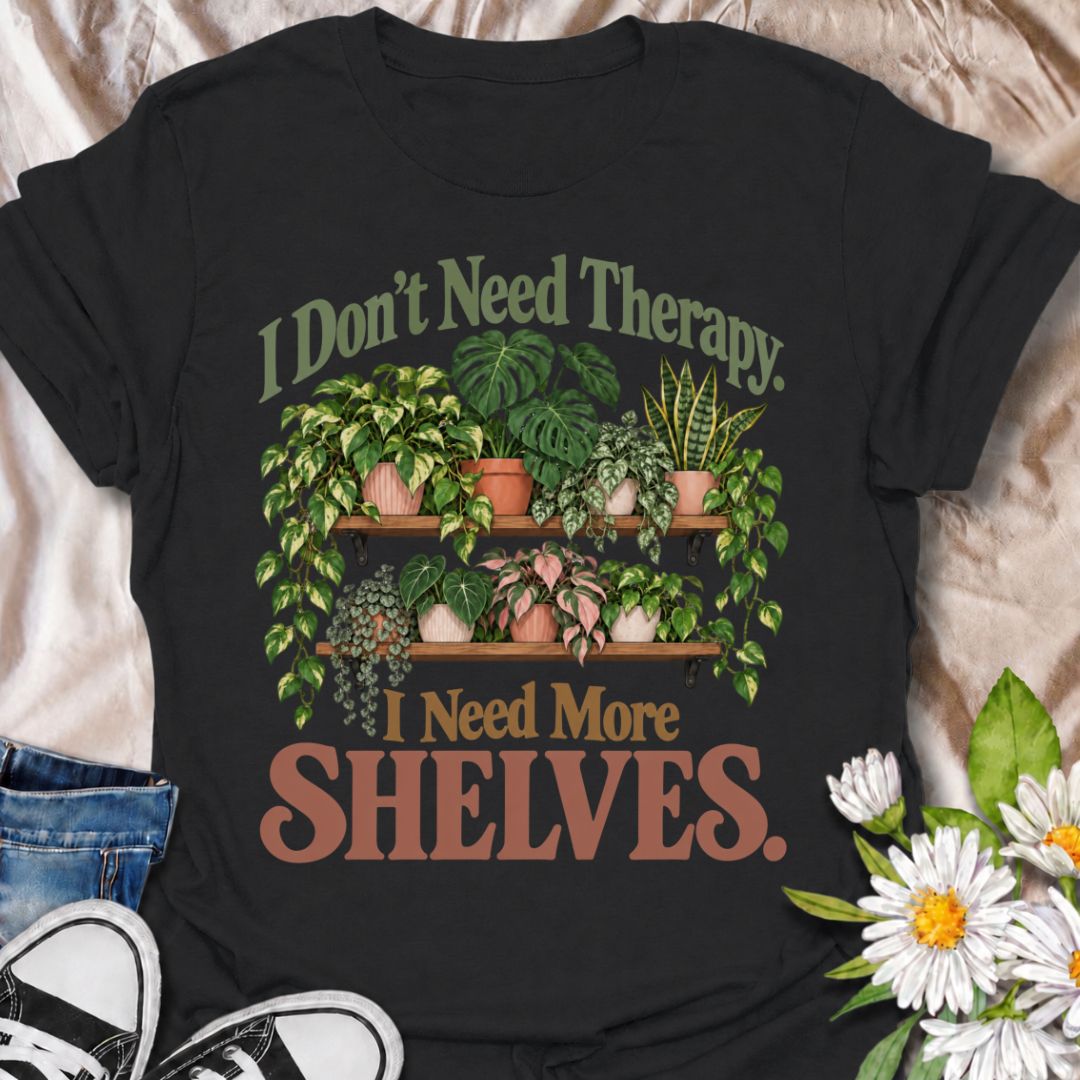 A funny houseplant T-shirt for anyone who has run out of room long before they have run out of plants. The phrase “I Don’t Need Therapy. I Need More Shelves.” pairs with overflowing plant shelves for a relatable houseplant-lover design with plenty of personality. It is perfect for plant parents, indoor gardeners, collectors, and anyone whose windowsills and surfaces are already completely occupied. The lush botanical artwork gives the design a fuller, more decorative look while keeping the joke easy to read