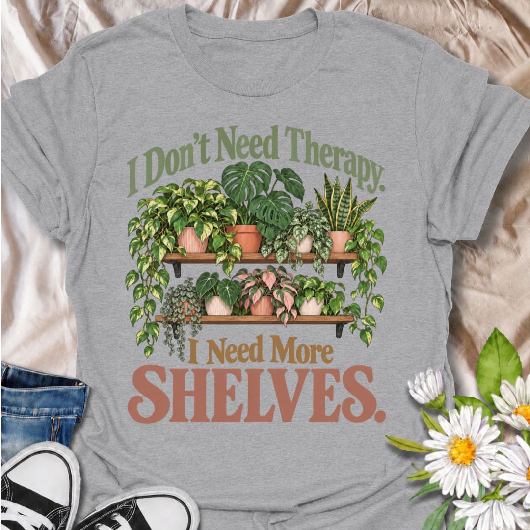 A funny houseplant T-shirt for anyone who has run out of room long before they have run out of plants. The phrase “I Don’t Need Therapy. I Need More Shelves.” pairs with overflowing plant shelves for a relatable houseplant-lover design with plenty of personality. It is perfect for plant parents, indoor gardeners, collectors, and anyone whose windowsills and surfaces are already completely occupied. The lush botanical artwork gives the design a fuller, more decorative look while keeping the joke easy to read