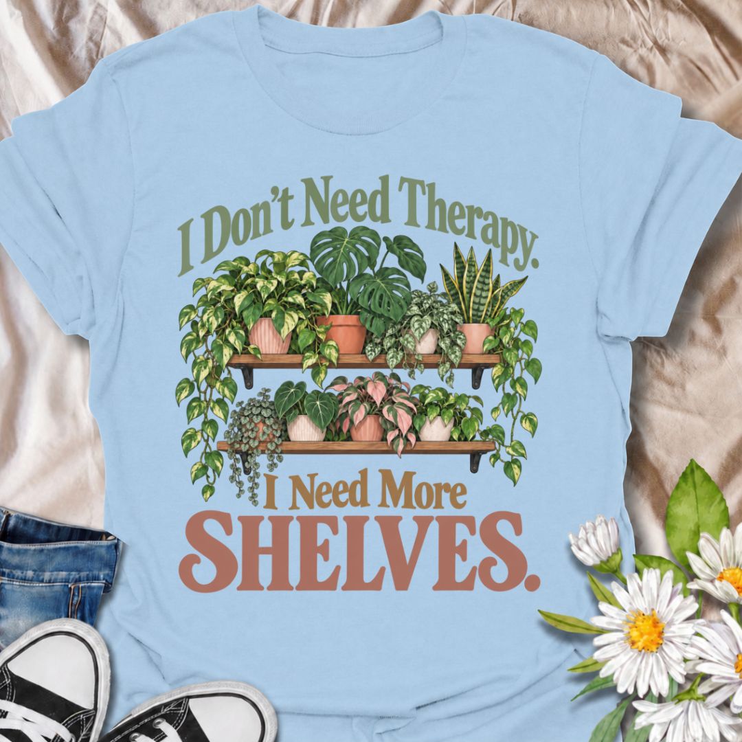 A funny houseplant T-shirt for anyone who has run out of room long before they have run out of plants. The phrase “I Don’t Need Therapy. I Need More Shelves.” pairs with overflowing plant shelves for a relatable houseplant-lover design with plenty of personality. It is perfect for plant parents, indoor gardeners, collectors, and anyone whose windowsills and surfaces are already completely occupied. The lush botanical artwork gives the design a fuller, more decorative look while keeping the joke easy to read