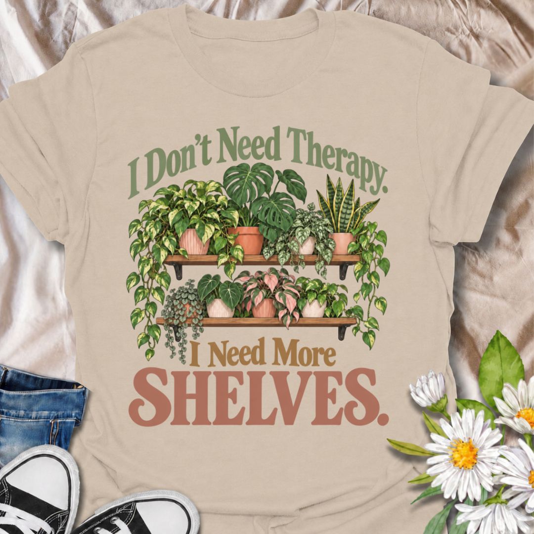 A funny houseplant T-shirt for anyone who has run out of room long before they have run out of plants. The phrase “I Don’t Need Therapy. I Need More Shelves.” pairs with overflowing plant shelves for a relatable houseplant-lover design with plenty of personality. It is perfect for plant parents, indoor gardeners, collectors, and anyone whose windowsills and surfaces are already completely occupied. The lush botanical artwork gives the design a fuller, more decorative look while keeping the joke easy to read
