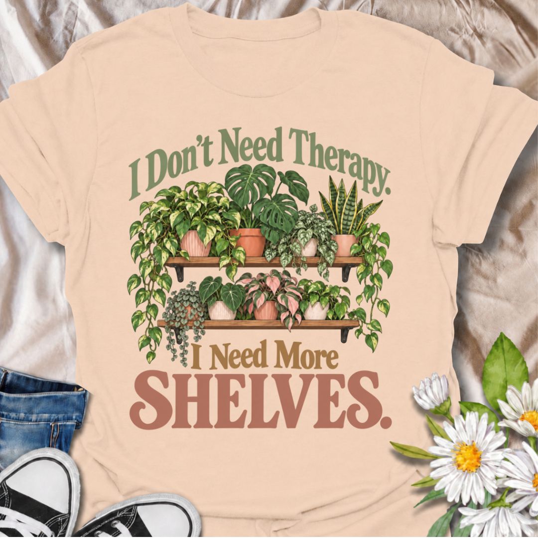 A funny houseplant T-shirt for anyone who has run out of room long before they have run out of plants. The phrase “I Don’t Need Therapy. I Need More Shelves.” pairs with overflowing plant shelves for a relatable houseplant-lover design with plenty of personality. It is perfect for plant parents, indoor gardeners, collectors, and anyone whose windowsills and surfaces are already completely occupied. The lush botanical artwork gives the design a fuller, more decorative look while keeping the joke easy to read
