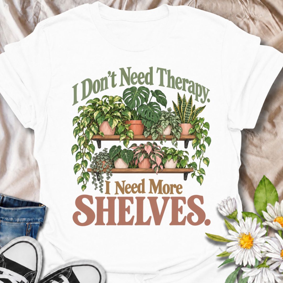 A funny houseplant T-shirt for anyone who has run out of room long before they have run out of plants. The phrase “I Don’t Need Therapy. I Need More Shelves.” pairs with overflowing plant shelves for a relatable houseplant-lover design with plenty of personality. It is perfect for plant parents, indoor gardeners, collectors, and anyone whose windowsills and surfaces are already completely occupied. The lush botanical artwork gives the design a fuller, more decorative look while keeping the joke easy to read