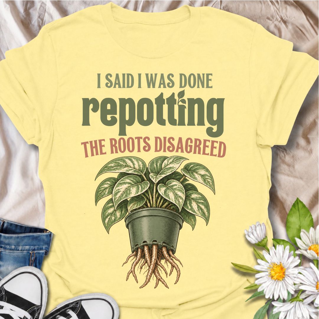 A funny houseplant T-shirt for anyone who thought they were finished repotting until the roots had other ideas. The phrase “I Said I Was Done Repotting. The Roots Disagreed.” captures one of those very familiar plant-parent problems with dry, relatable humor. Featuring a lush potted houseplant with roots pushing through the drainage holes, this design is perfect for indoor gardeners, plant collectors, and anyone constantly upsizing pots. It makes a great gift for pothos lovers, houseplant enthusiasts, and p