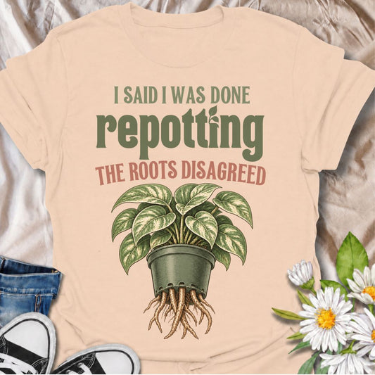 A funny houseplant T-shirt for anyone who thought they were finished repotting until the roots had other ideas. The phrase “I Said I Was Done Repotting. The Roots Disagreed.” captures one of those very familiar plant-parent problems with dry, relatable humor. Featuring a lush potted houseplant with roots pushing through the drainage holes, this design is perfect for indoor gardeners, plant collectors, and anyone constantly upsizing pots. It makes a great gift for pothos lovers, houseplant enthusiasts, and p