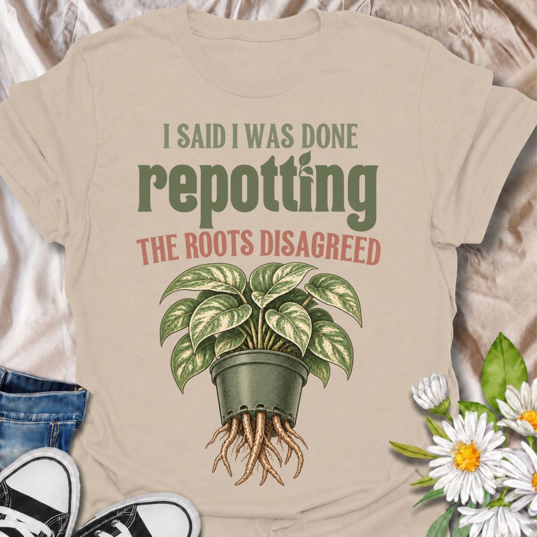 A funny houseplant T-shirt for anyone who thought they were finished repotting until the roots had other ideas. The phrase “I Said I Was Done Repotting. The Roots Disagreed.” captures one of those very familiar plant-parent problems with dry, relatable humor. Featuring a lush potted houseplant with roots pushing through the drainage holes, this design is perfect for indoor gardeners, plant collectors, and anyone constantly upsizing pots. It makes a great gift for pothos lovers, houseplant enthusiasts, and p