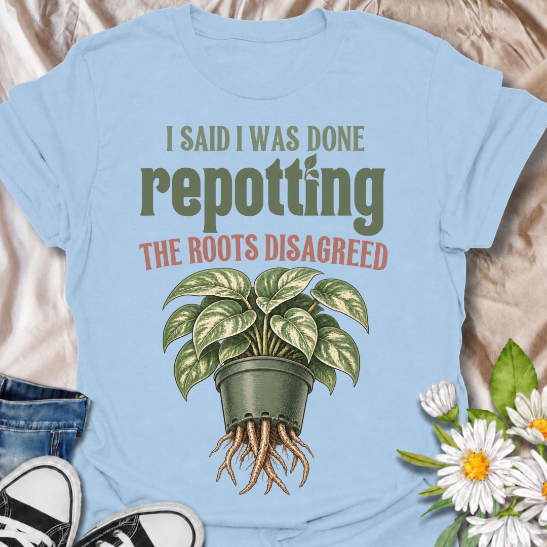 A funny houseplant T-shirt for anyone who thought they were finished repotting until the roots had other ideas. The phrase “I Said I Was Done Repotting. The Roots Disagreed.” captures one of those very familiar plant-parent problems with dry, relatable humor. Featuring a lush potted houseplant with roots pushing through the drainage holes, this design is perfect for indoor gardeners, plant collectors, and anyone constantly upsizing pots. It makes a great gift for pothos lovers, houseplant enthusiasts, and p
