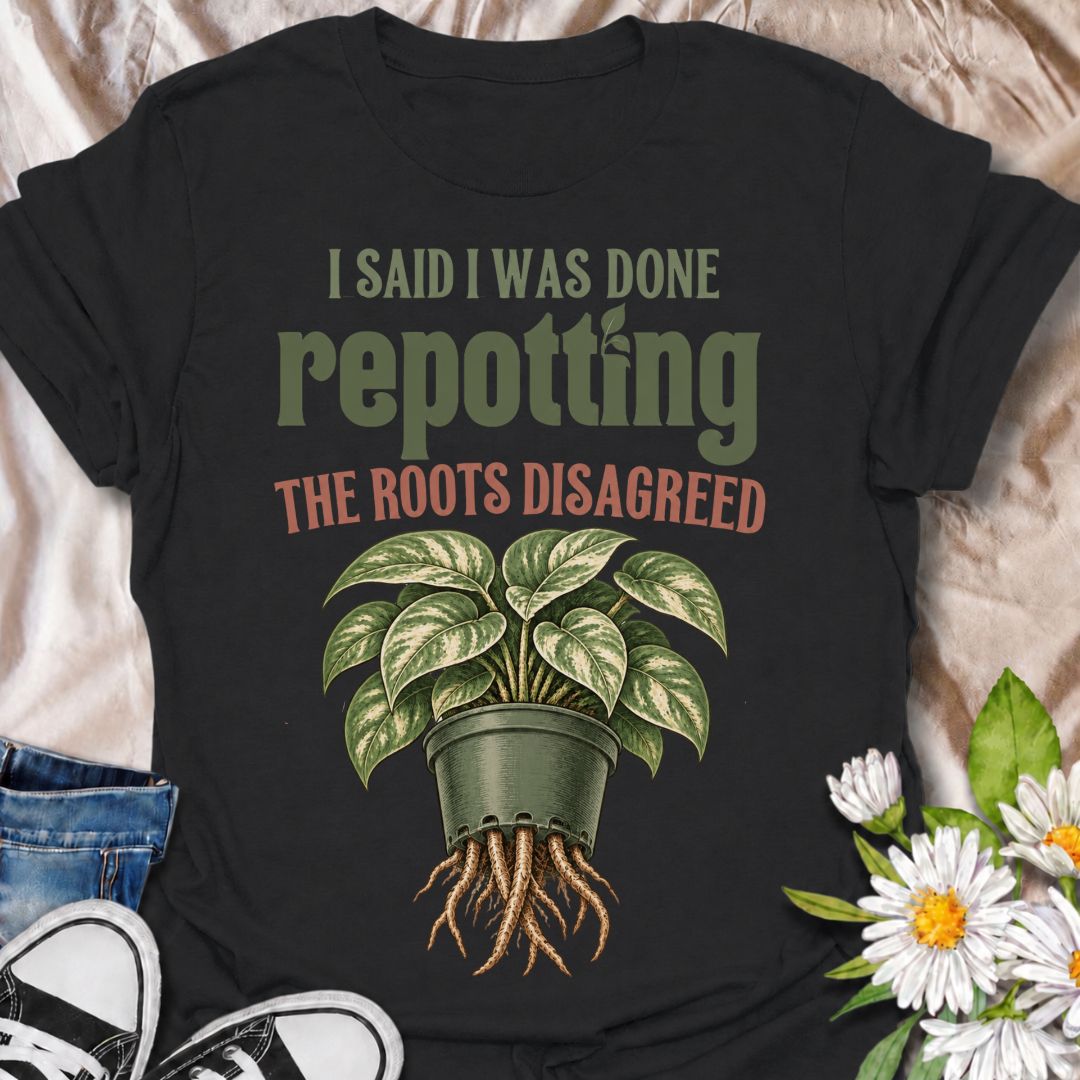 A funny houseplant T-shirt for anyone who thought they were finished repotting until the roots had other ideas. The phrase “I Said I Was Done Repotting. The Roots Disagreed.” captures one of those very familiar plant-parent problems with dry, relatable humor. Featuring a lush potted houseplant with roots pushing through the drainage holes, this design is perfect for indoor gardeners, plant collectors, and anyone constantly upsizing pots. It makes a great gift for pothos lovers, houseplant enthusiasts, and p