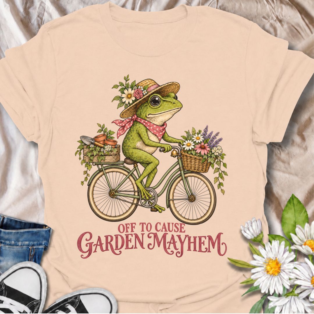 A funny gardening T-shirt for anyone who heads into the garden with good intentions and somehow creates a little chaos along the way. Featuring a cheerful frog riding a bicycle loaded with flowers, pots, and garden supplies, the phrase “Off to Cause Garden Mayhem” gives the design playful, character-led humor. It is perfect for gardeners, flower lovers, frog fans, and anyone who treats a trip around the garden like an adventure. The vintage-style artwork gives it plenty of charm while keeping the joke easy 