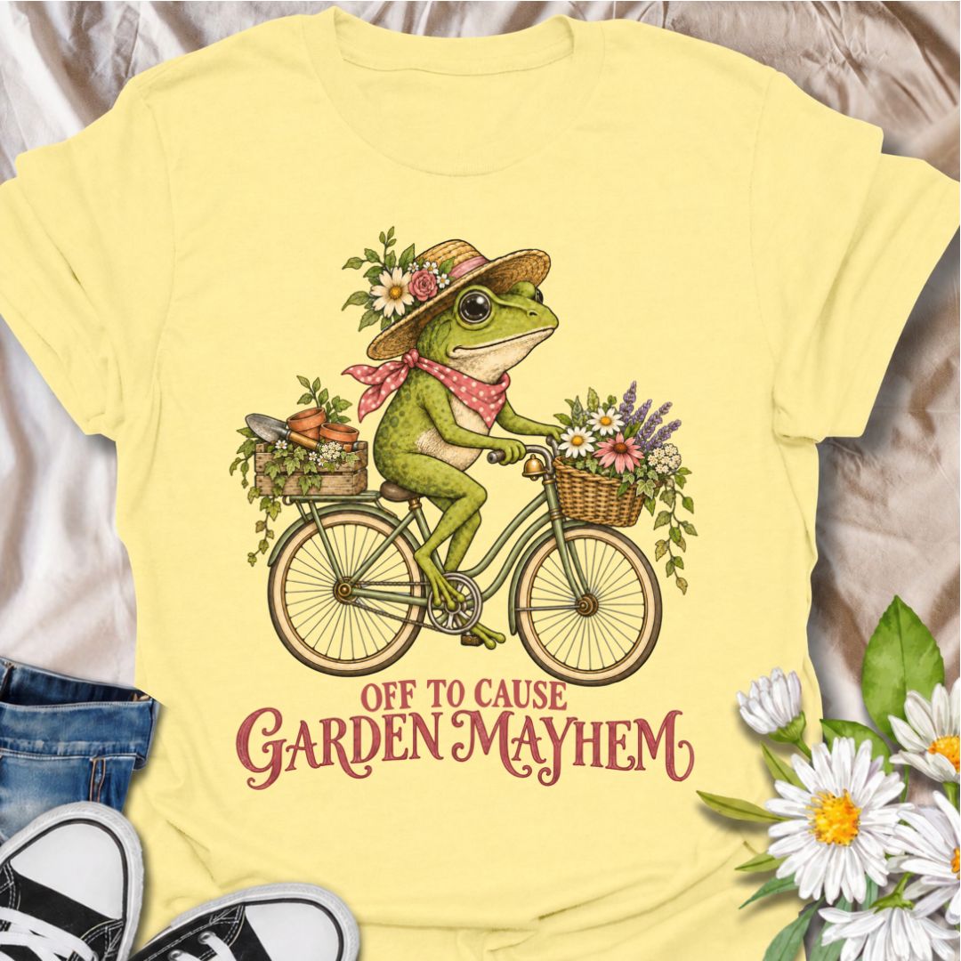 A funny gardening T-shirt for anyone who heads into the garden with good intentions and somehow creates a little chaos along the way. Featuring a cheerful frog riding a bicycle loaded with flowers, pots, and garden supplies, the phrase “Off to Cause Garden Mayhem” gives the design playful, character-led humor. It is perfect for gardeners, flower lovers, frog fans, and anyone who treats a trip around the garden like an adventure. The vintage-style artwork gives it plenty of charm while keeping the joke easy 