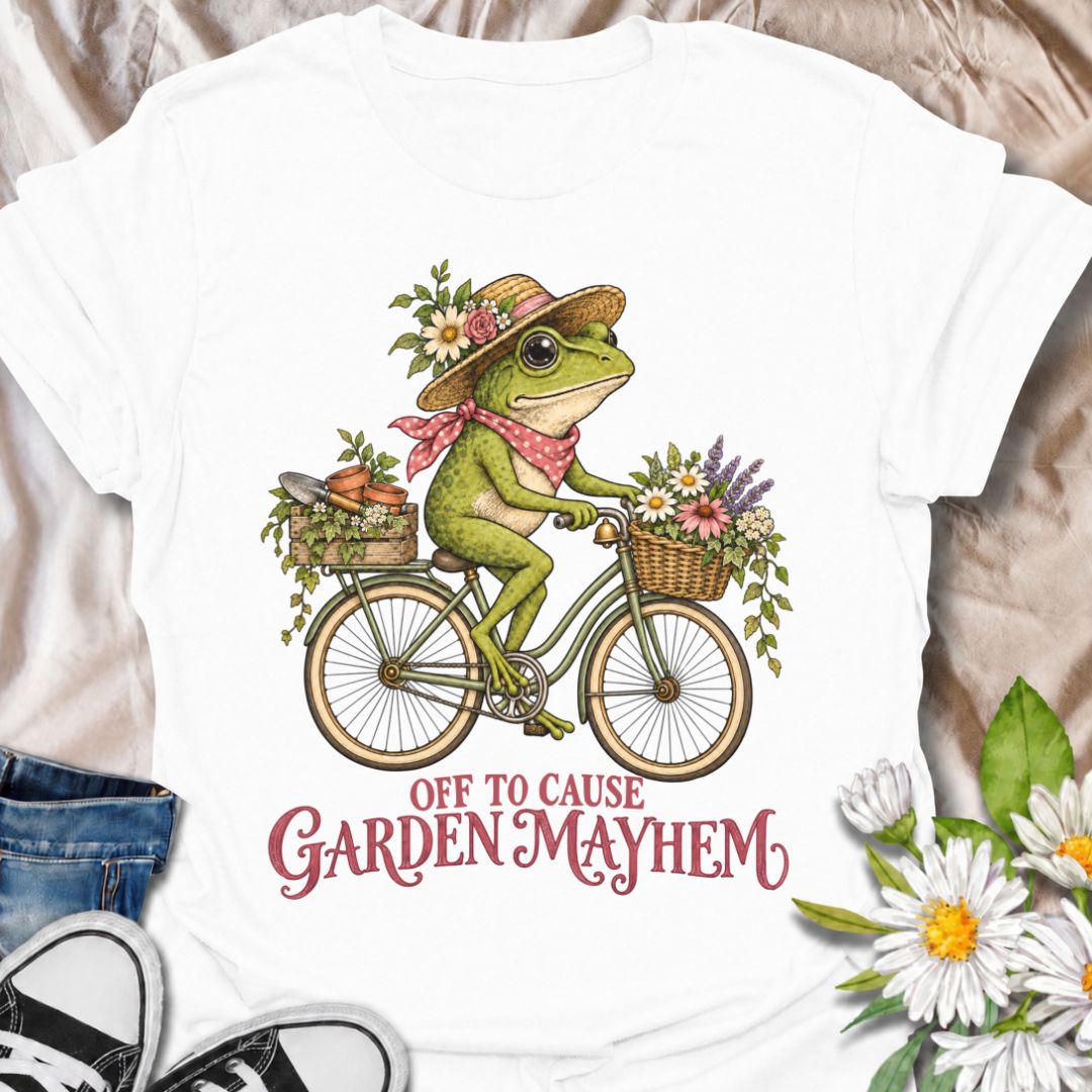 A funny gardening T-shirt for anyone who heads into the garden with good intentions and somehow creates a little chaos along the way. Featuring a cheerful frog riding a bicycle loaded with flowers, pots, and garden supplies, the phrase “Off to Cause Garden Mayhem” gives the design playful, character-led humor. It is perfect for gardeners, flower lovers, frog fans, and anyone who treats a trip around the garden like an adventure. The vintage-style artwork gives it plenty of charm while keeping the joke easy 