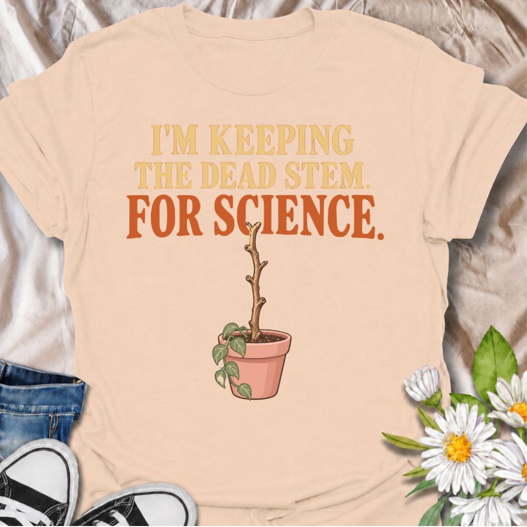 A funny houseplant T-shirt for anyone who keeps a questionable stem around “just in case” there is still some life left in it. The phrase “I’m Keeping the Dead Stem. For Science.” delivers dry, self-aware plant-parent humor that houseplant lovers will instantly understand. Featuring a sad little potted plant with one stubborn dead stem, the design is perfect for indoor gardeners, plant collectors, and anyone who has delayed giving up on a struggling plant. It makes a great gift for plant parents who overthi