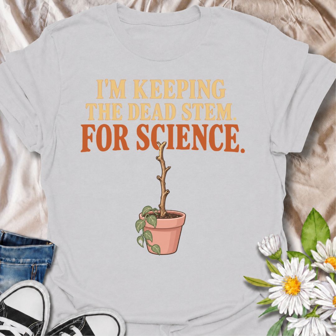 A funny houseplant T-shirt for anyone who keeps a questionable stem around “just in case” there is still some life left in it. The phrase “I’m Keeping the Dead Stem. For Science.” delivers dry, self-aware plant-parent humor that houseplant lovers will instantly understand. Featuring a sad little potted plant with one stubborn dead stem, the design is perfect for indoor gardeners, plant collectors, and anyone who has delayed giving up on a struggling plant. It makes a great gift for plant parents who overthi