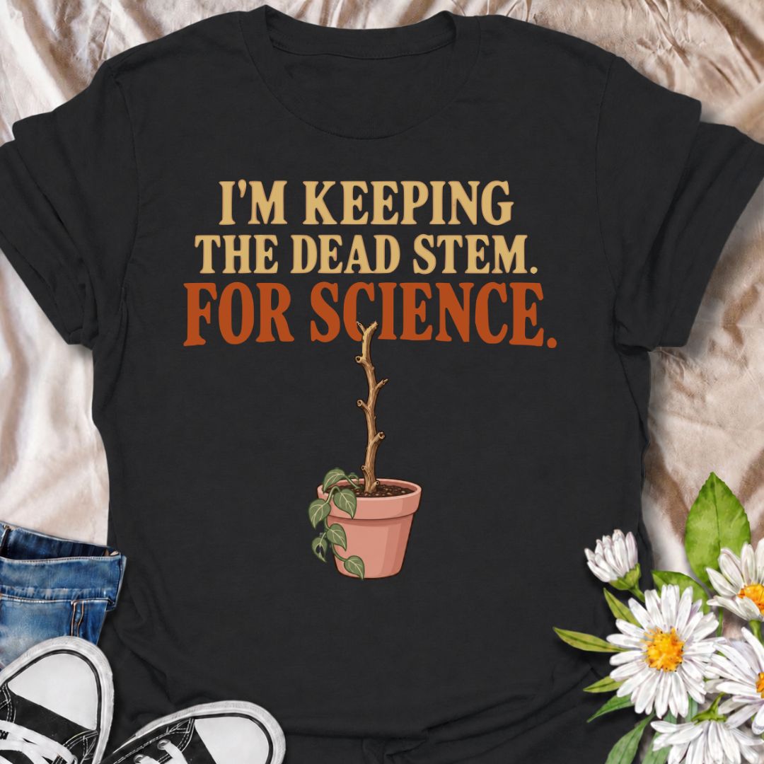 A funny houseplant T-shirt for anyone who keeps a questionable stem around “just in case” there is still some life left in it. The phrase “I’m Keeping the Dead Stem. For Science.” delivers dry, self-aware plant-parent humor that houseplant lovers will instantly understand. Featuring a sad little potted plant with one stubborn dead stem, the design is perfect for indoor gardeners, plant collectors, and anyone who has delayed giving up on a struggling plant. It makes a great gift for plant parents who overthi