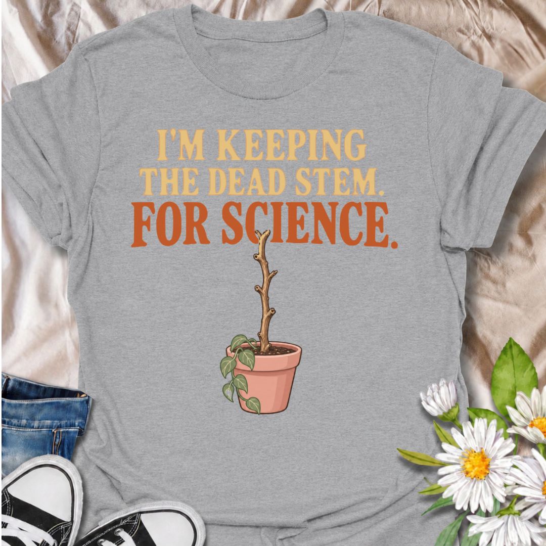 A funny houseplant T-shirt for anyone who keeps a questionable stem around “just in case” there is still some life left in it. The phrase “I’m Keeping the Dead Stem. For Science.” delivers dry, self-aware plant-parent humor that houseplant lovers will instantly understand. Featuring a sad little potted plant with one stubborn dead stem, the design is perfect for indoor gardeners, plant collectors, and anyone who has delayed giving up on a struggling plant. It makes a great gift for plant parents who overthi