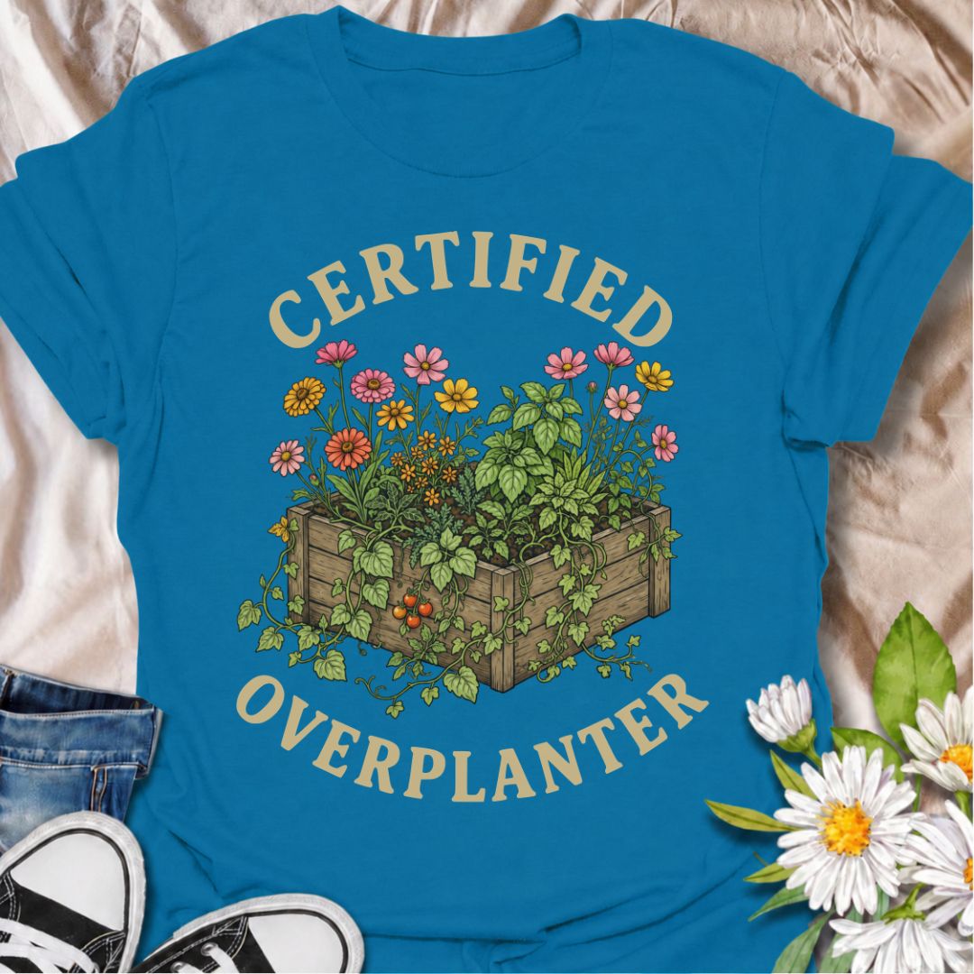 A funny gardening T-shirt for anyone who sees an empty patch of soil and immediately fills every inch of it. The “Certified Overplanter” phrase pairs with a packed raised bed overflowing with flowers, herbs, and vegetables for a design that real gardeners will instantly recognize. It is perfect for cottage gardeners, backyard growers, raised-bed gardeners, and anyone who treats recommended spacing as more of a suggestion than a rule. The vintage-style botanical artwork gives the design plenty of detail whil