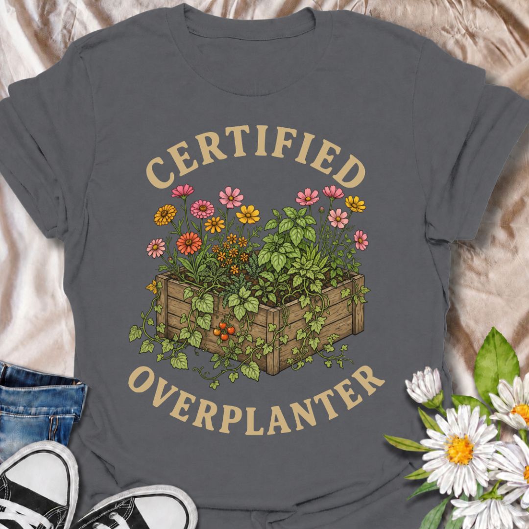 A funny gardening T-shirt for anyone who sees an empty patch of soil and immediately fills every inch of it. The “Certified Overplanter” phrase pairs with a packed raised bed overflowing with flowers, herbs, and vegetables for a design that real gardeners will instantly recognize. It is perfect for cottage gardeners, backyard growers, raised-bed gardeners, and anyone who treats recommended spacing as more of a suggestion than a rule. The vintage-style botanical artwork gives the design plenty of detail whil