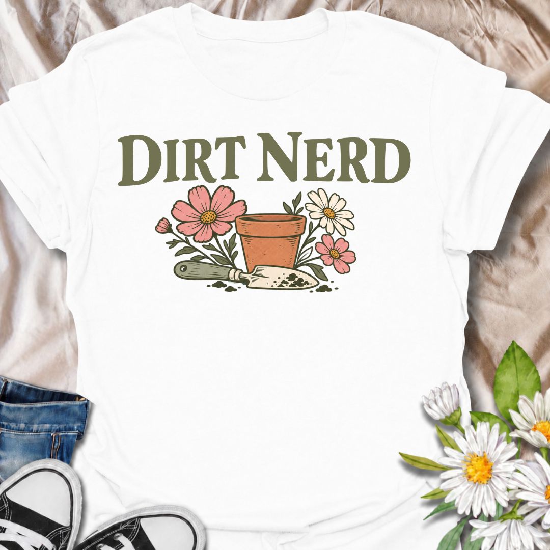 A playful gardening T-shirt for anyone who genuinely gets excited about soil, pots, planting, and everything that goes with growing things. The simple “Dirt Nerd” phrase pairs with flowers, a terracotta pot, and hand trowel for a clean garden-lover design with plenty of personality. It is perfect for backyard gardeners, flower growers, cottage gardeners, and anyone who is happiest with their hands in the soil. The soft vintage-style artwork keeps the design cheerful and easy to wear. A great gift for garden