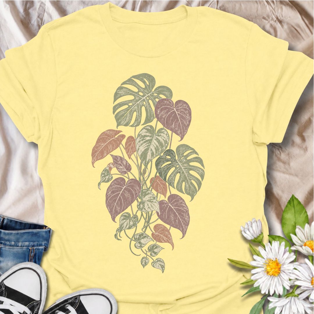 A soft botanical T-shirt for plant lovers who prefer their greenery with a more subtle, feminine feel. Featuring layered monstera, philodendron, and trailing leaves in muted sage, dusty rose, and soft plum tones, this design has an understated vintage look that works beautifully for everyday wear. It is perfect for houseplant lovers, indoor gardeners, botanical enthusiasts, and anyone who enjoys nature-inspired clothing without a slogan. The faded palette gives the artwork a relaxed, slightly worn-in feel w