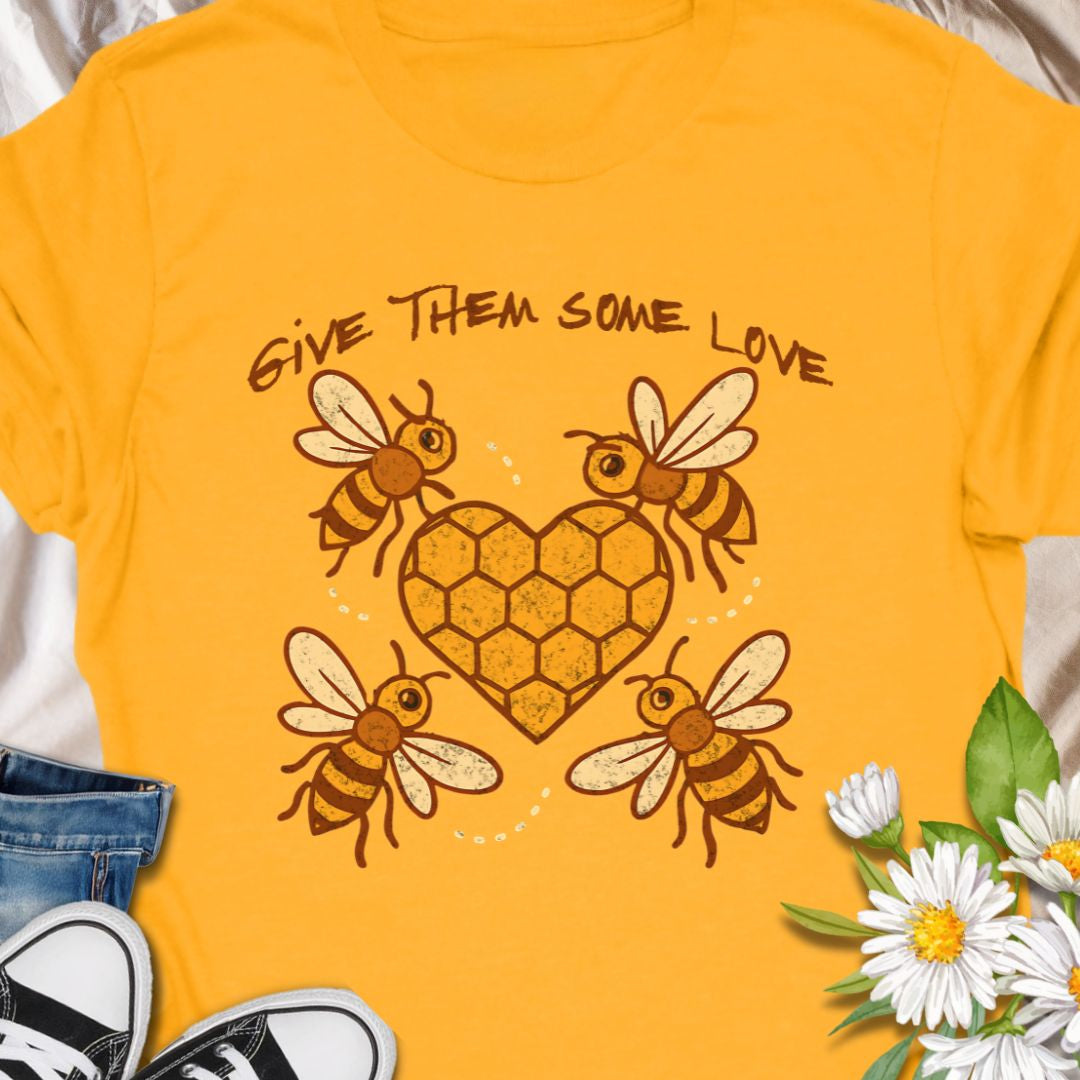 Show your support for the bees with this adorable “Give Them Some Love” t-shirt featuring four cartoon bees buzzing around a heart-shaped honeycomb. It’s the perfect nature-inspired shirt for bee lovers, pollinator advocates, and environmentalists. A sweet way to spread awareness and style!