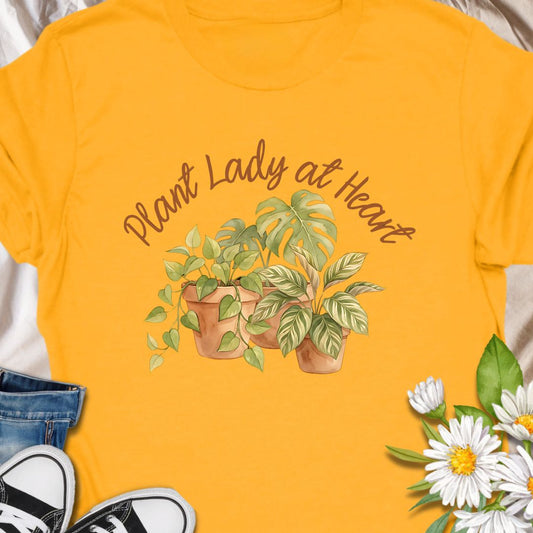 Celebrate your love for greenery with this charming “Plant Lady at Heart” t-shirt. Featuring soft water color-style potted plants and elegant script text, it’s the perfect gift for plant moms, gardeners, and nature enthusiasts. Wear it proudly and show the world that your heart truly belongs to plants—comfort meets style in this must-have tee.