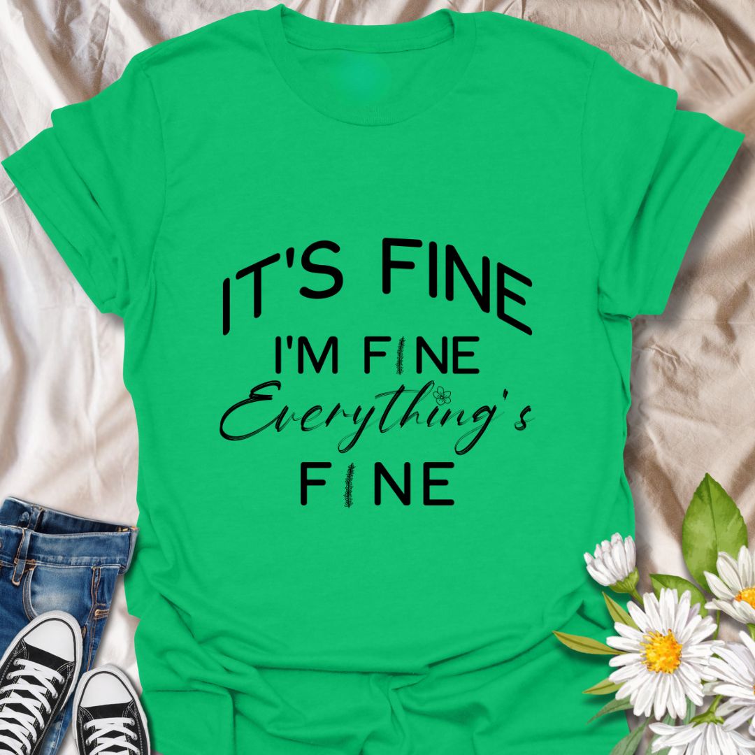 Keep it together (barely) with this humorous “It’s Fine. I’m Fine. Everything’s Fine” t-shirt. A relatable design with playful typography and a subtle floral touch—perfect for those who handle chaos with a smile.