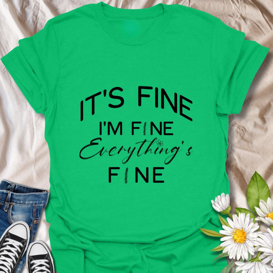 Keep it together (barely) with this humorous “It’s Fine. I’m Fine. Everything’s Fine” t-shirt. A relatable design with playful typography and a subtle floral touch—perfect for those who handle chaos with a smile.