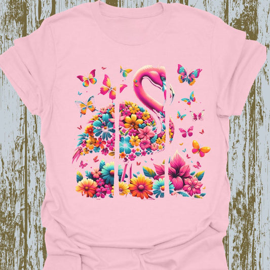 A design featuring flamingos, butterflies, and flowers in pink, yellow, and blue hues on pink t-shirt.