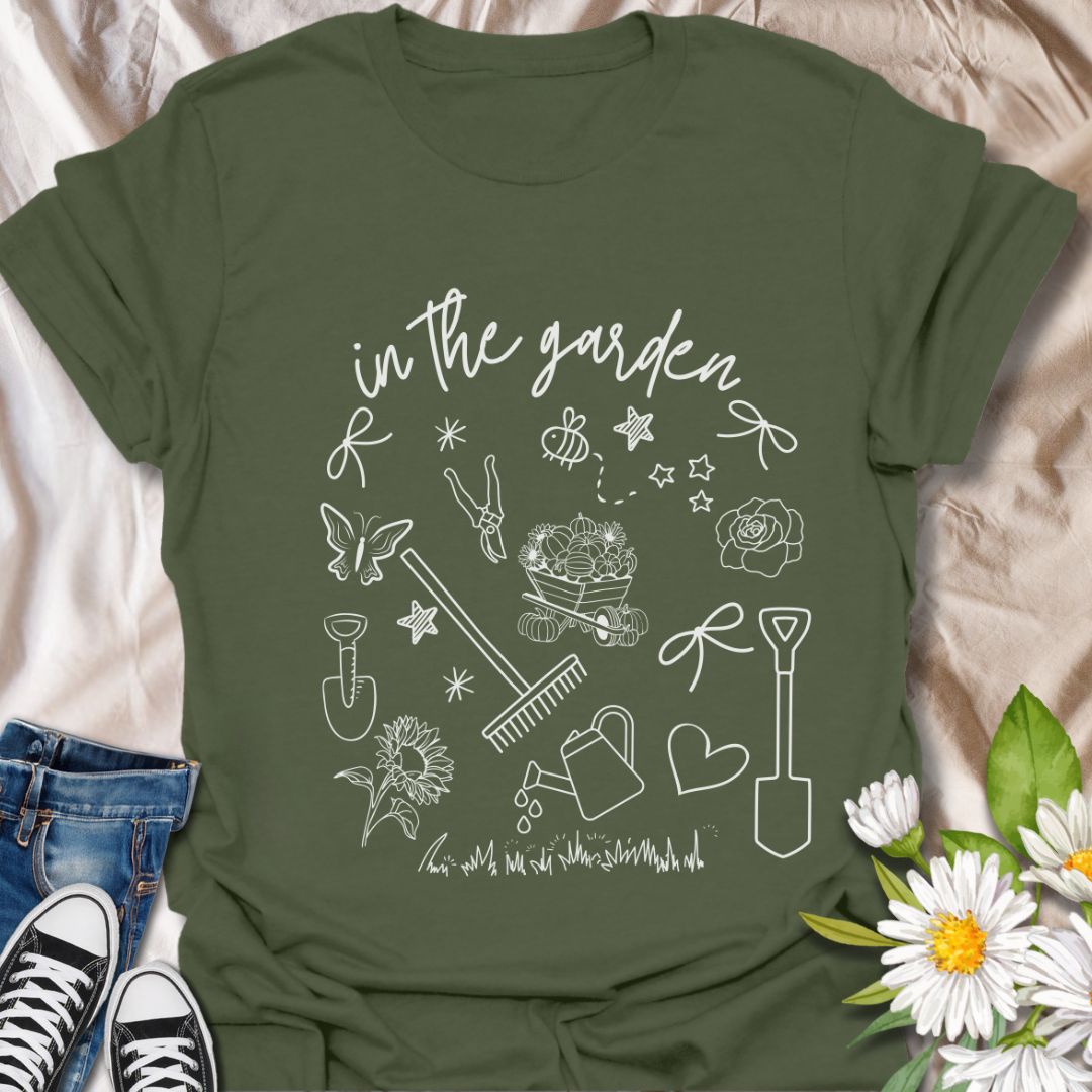 Charming "In The Garden" doodle style t-shirt with hand-drawn gardening tools, flowers, and butterflies. Perfect gift for gardeners, plant lovers, and nature enthusiasts. Stylish botanical apparel for spring, summer, or everyday wear. Celebrate your green thumb!