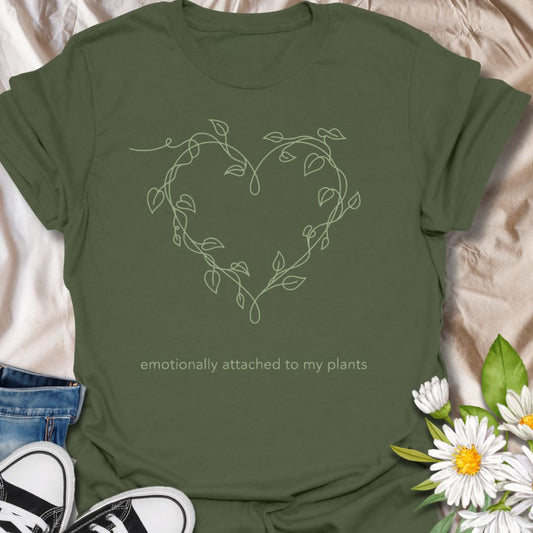 Minimalist plant lover t-shirt featuring a delicate vine heart and “emotionally attached to my plants.” Perfect for plant parents, houseplant lovers, and botanical aesthetics. A soft, nature-inspired tee ideal for everyday wear or thoughtful gifting.