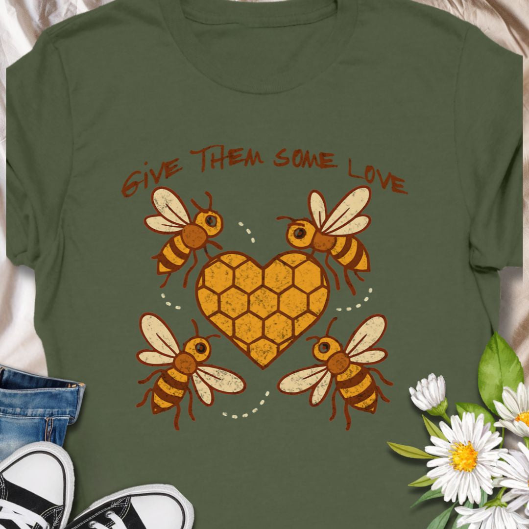 Show your support for the bees with this adorable “Give Them Some Love” t-shirt featuring four cartoon bees buzzing around a heart-shaped honeycomb. It’s the perfect nature-inspired shirt for bee lovers, pollinator advocates, and environmentalists. A sweet way to spread awareness and style!