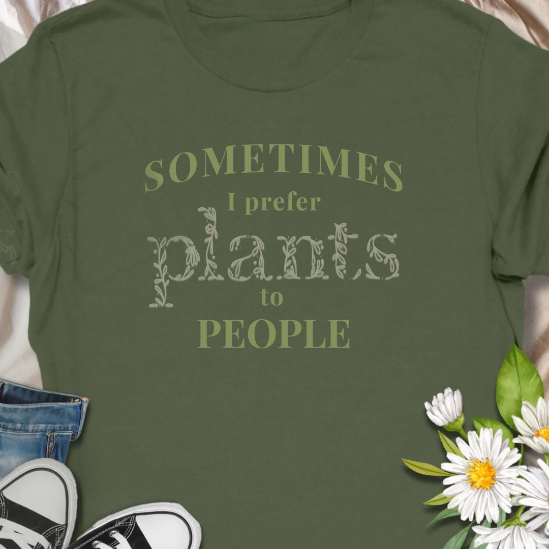 This tee speaks to the plant-lover who finds calm in soil, leaves, and slow-growing routines. The muted, nature-toned print reads “Sometimes I prefer plants to people,” a little wry and wholly relatable. Wear it while tending a crowded windowsill, carrying new finds home from the nursery, or lounging with a book as your succulents soak up afternoon light. 