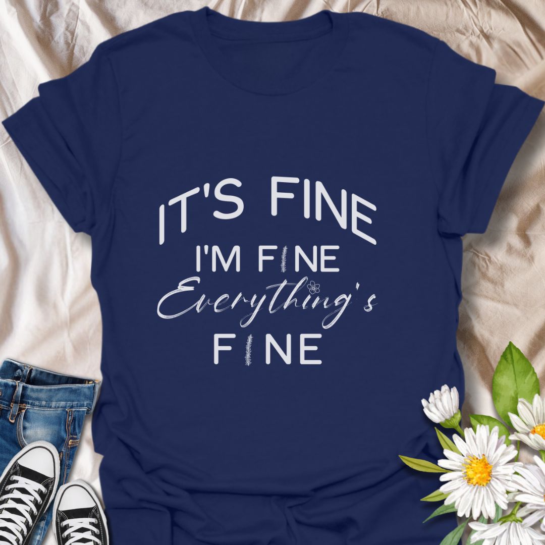 Keep it together (barely) with this humorous “It’s Fine. I’m Fine. Everything’s Fine” t-shirt. A relatable design with playful typography and a subtle floral touch—perfect for those who handle chaos with a smile.