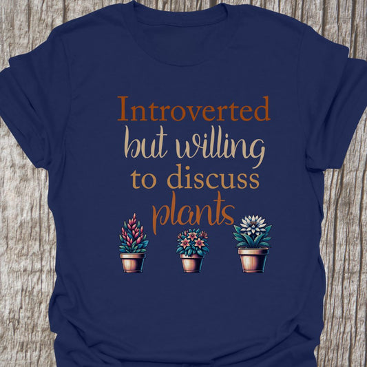 Introverted but willing to discuss plants in natural colored text with image of three flowering pot plants, on a navy blue t-shirt