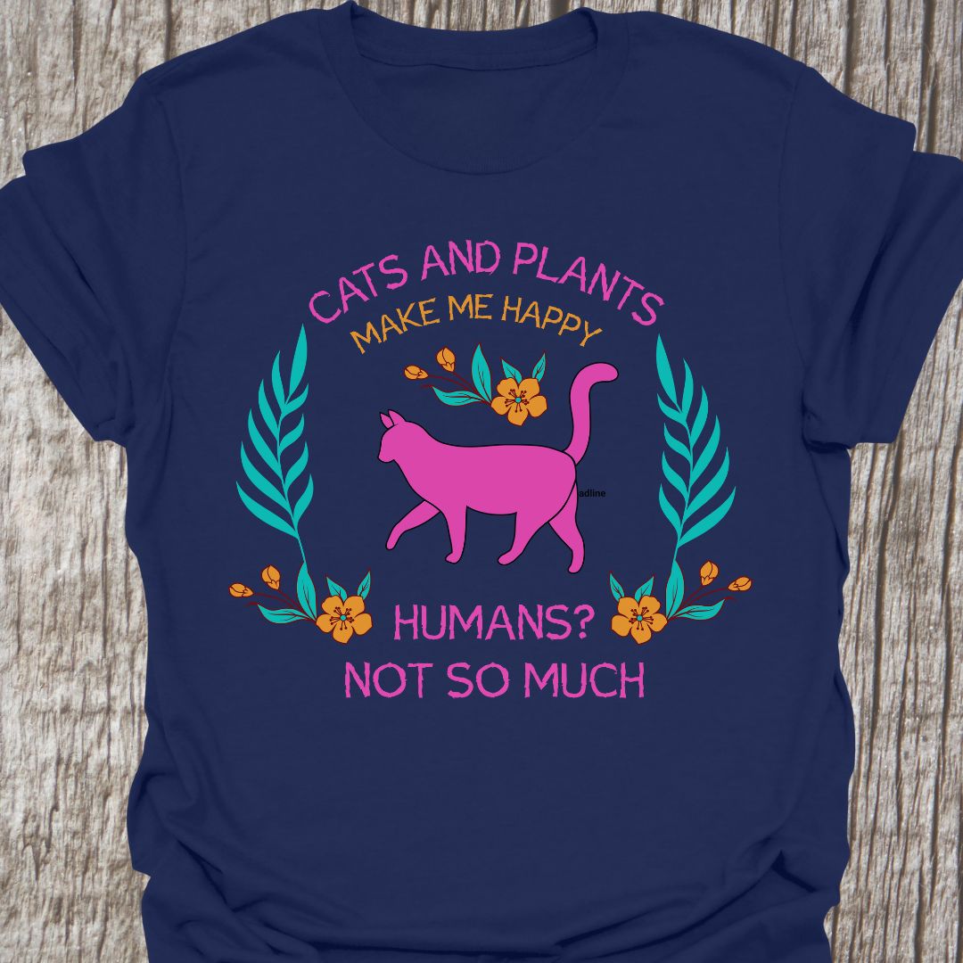 Cat and Plants Make Me Happy, Humans? Not So Much text and image design with pink cat as main image and decorative leaves, and flowers.  Navy t-shirt