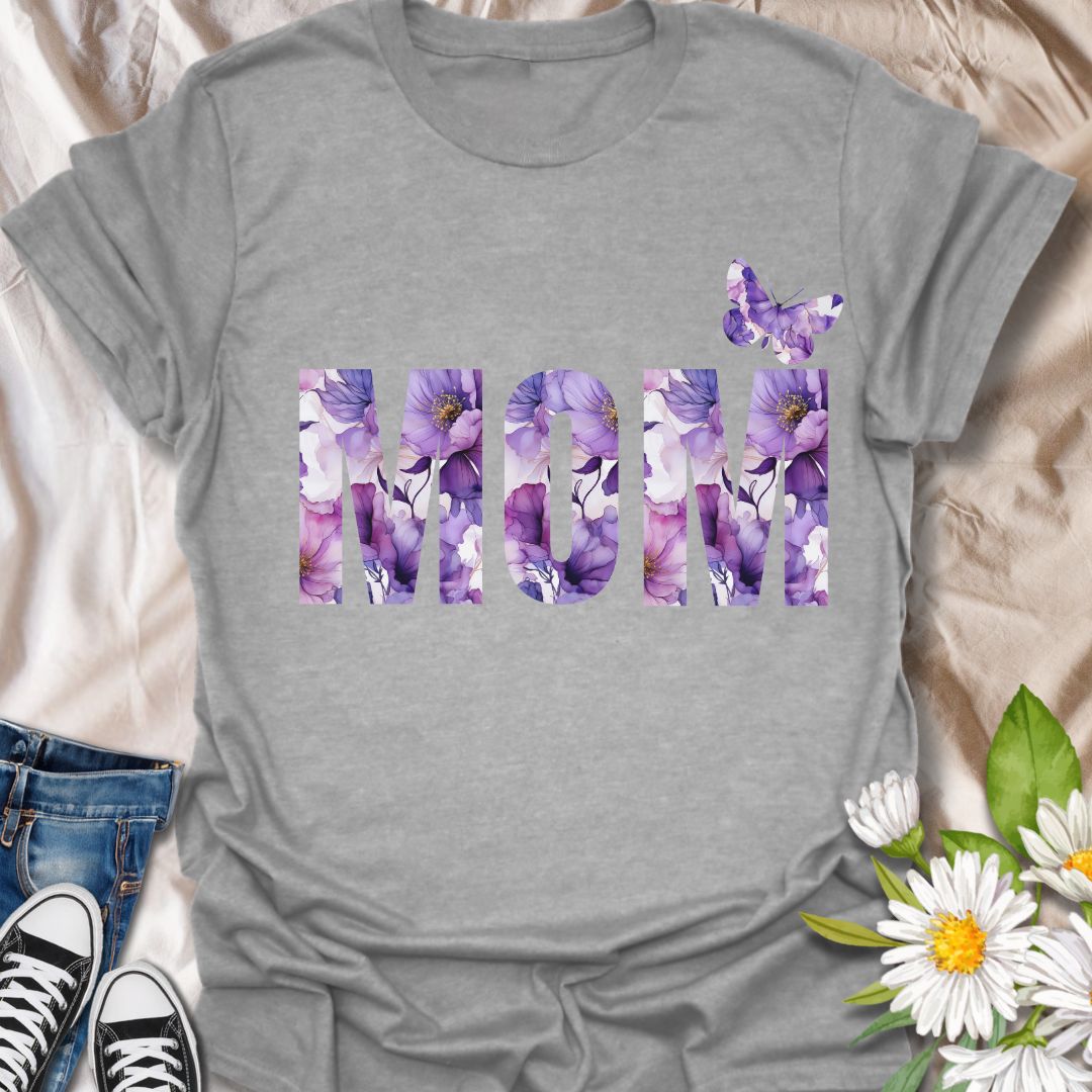 Beautiful floral “MOM” t-shirt with elegant purple and pink watercolor blooms and a butterfly accent. Perfect Mother's Day gift or everyday wear for plant moms, flower lovers, and garden enthusiasts. Celebrate motherhood with botanical charm.