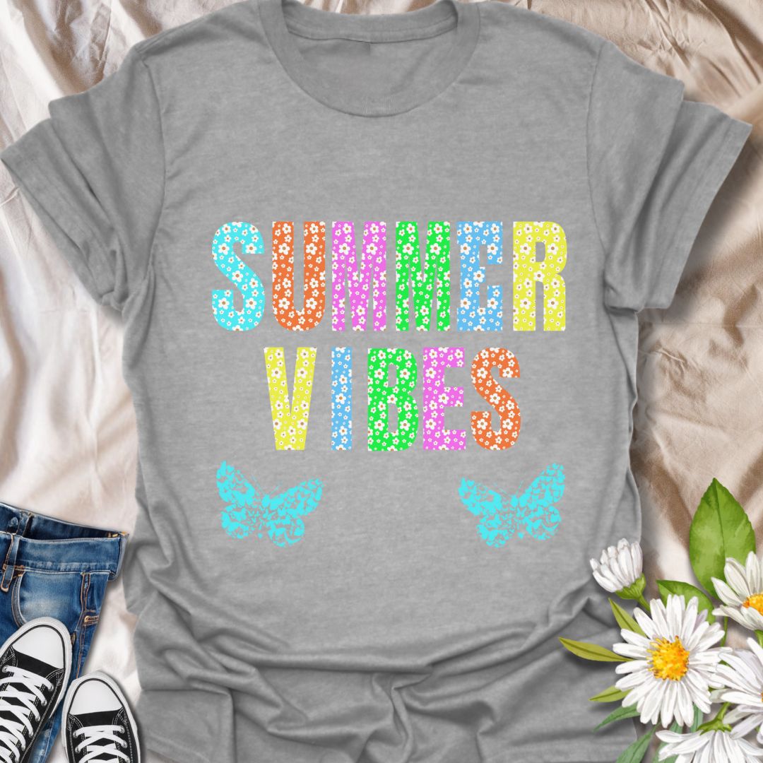 Bright and colorful "Summer Vibes" t-shirt with bold floral letters and butterfly accents. Perfect summer fashion for beach trips, vacations, festivals, or casual days. Ideal gift for anyone who loves sunshine, flowers, and vibrant summer style.