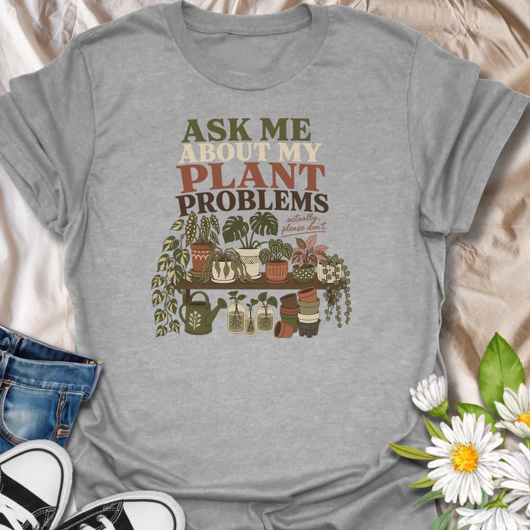 Invite a very long conversation with this “Ask Me About My Plant Problems” T-shirt. Featuring a collection of thriving, trailing, and slightly dramatic houseplants, it is ideal for plant parents who always have a care story to share. A funny botanical gift for houseplant collectors and indoor gardeners.