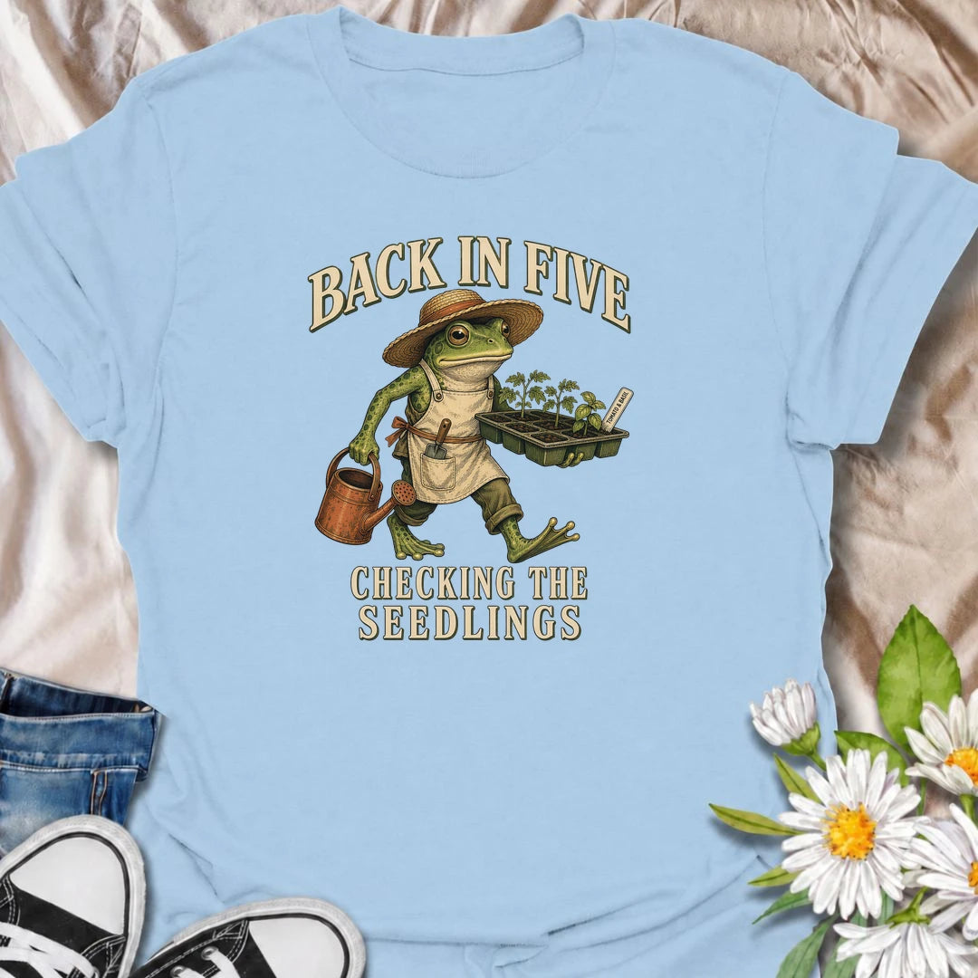Funny gardening T-shirt for plant lovers who are always disappearing to check seedlings, water pots or inspect the garden. Features a vintage frog gardener illustration and playful “Back in Five, Checking the Seedlings” design for gardeners, growers and houseplant fans.