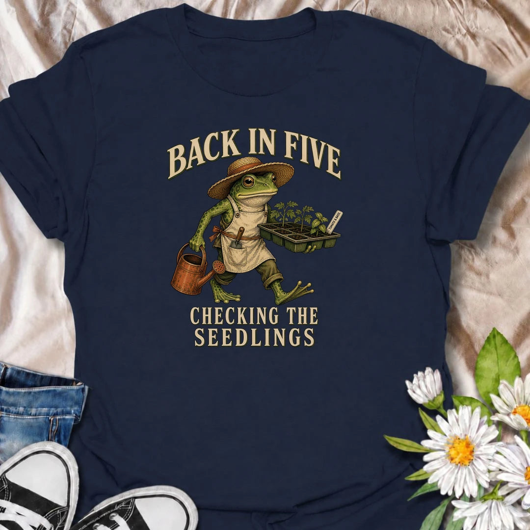 Funny gardening T-shirt for plant lovers who are always disappearing to check seedlings, water pots or inspect the garden. Features a vintage frog gardener illustration and playful “Back in Five, Checking the Seedlings” design for gardeners, growers and houseplant fans.