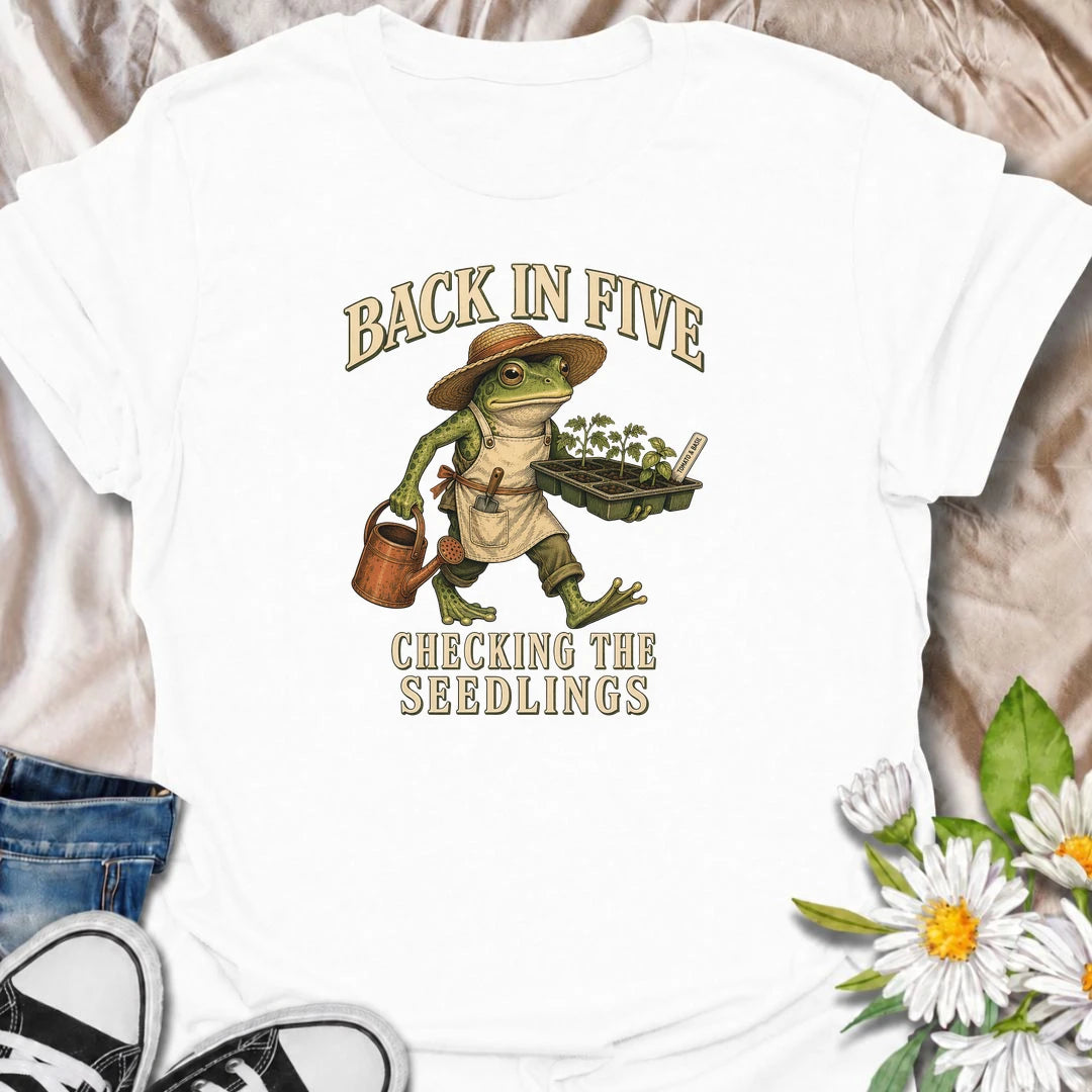 Funny gardening T-shirt for plant lovers who are always disappearing to check seedlings, water pots or inspect the garden. Features a vintage frog gardener illustration and playful “Back in Five, Checking the Seedlings” design for gardeners, growers and houseplant fans.